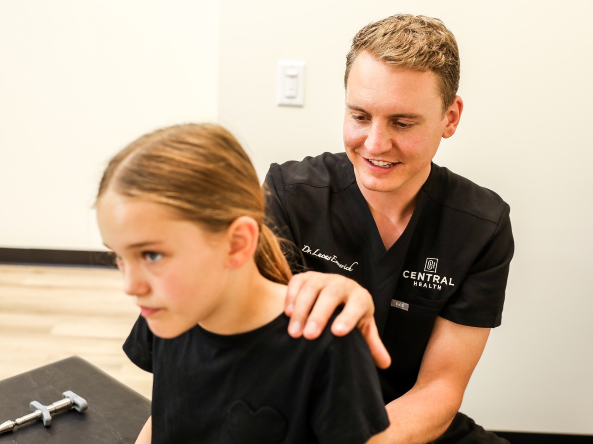 Dr. Emmerich checking a young girl's neck