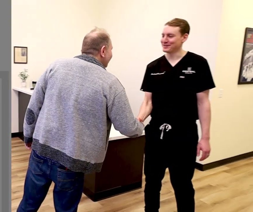 Dr. Emmerich greeting a patient at the front desk