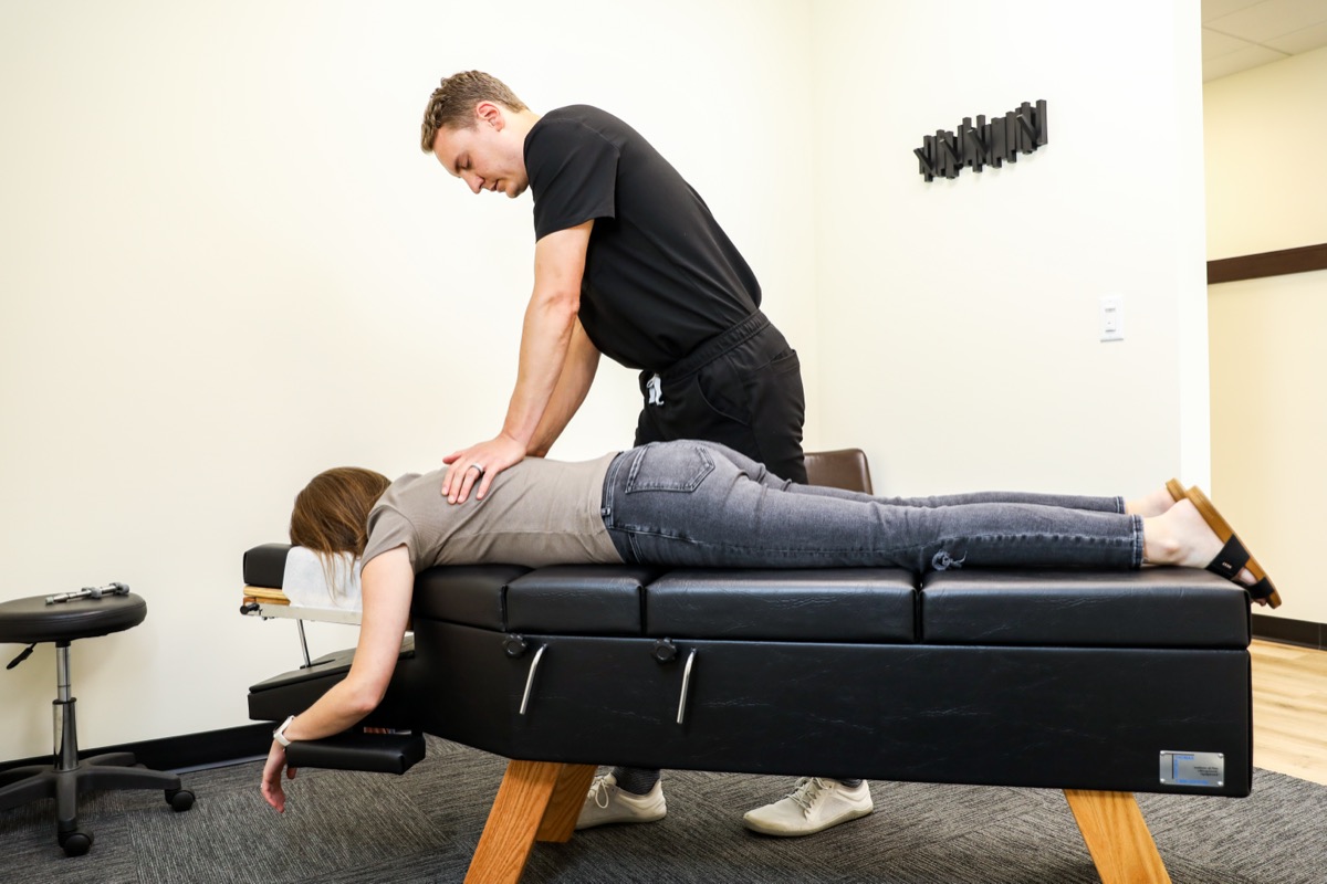 Dr. Emmerich adjusting a patient lying face down
