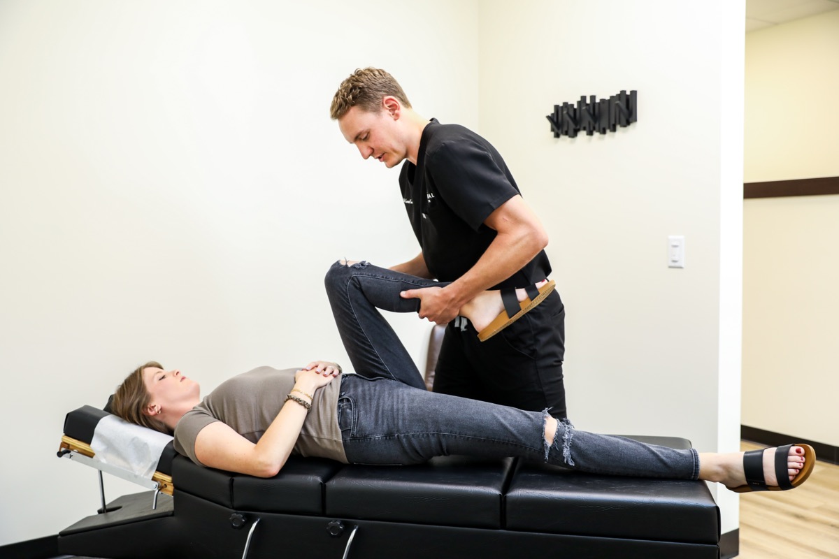 Dr. Emmerich checking a patient's knee on the table