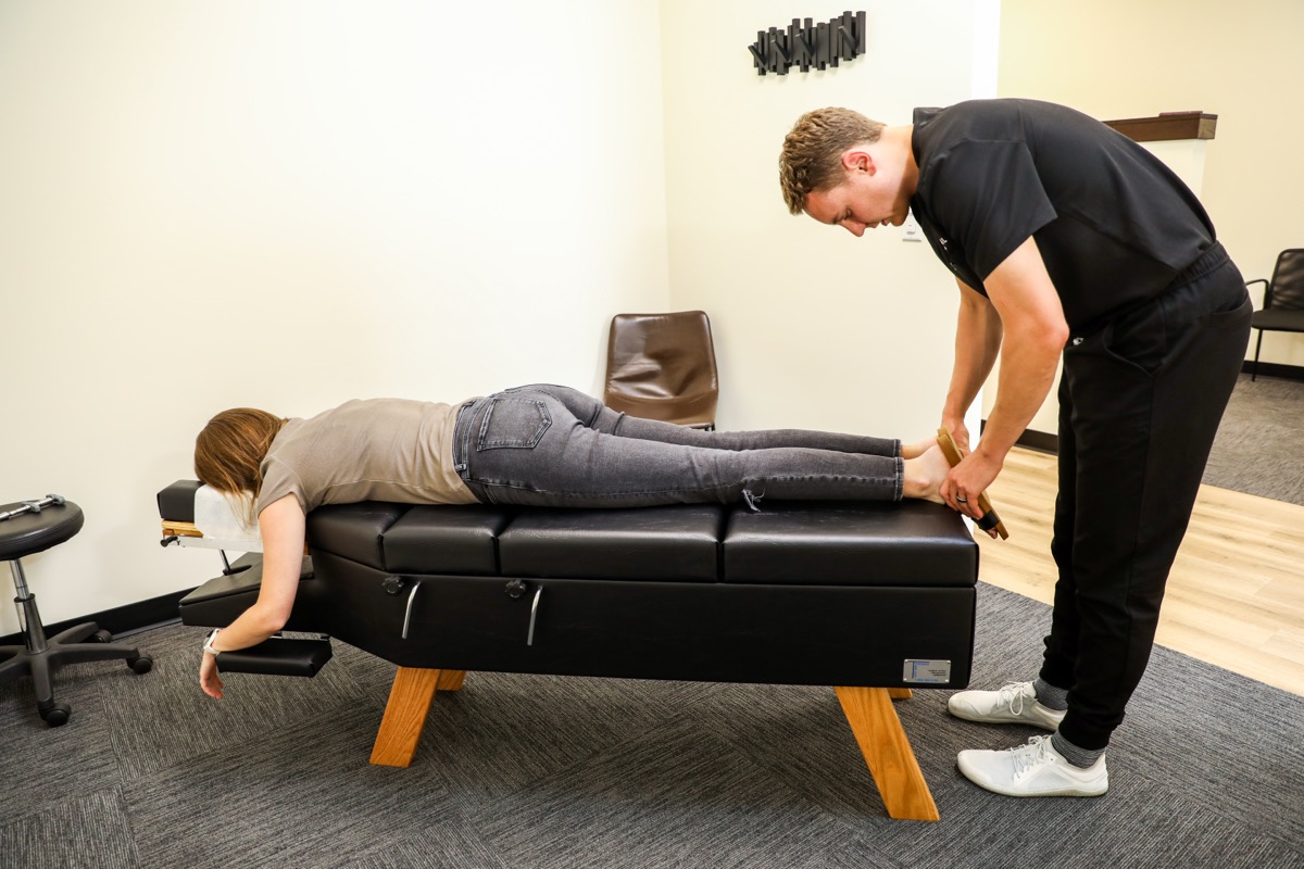 Dr. Emmerich checking a patient's leg on the table