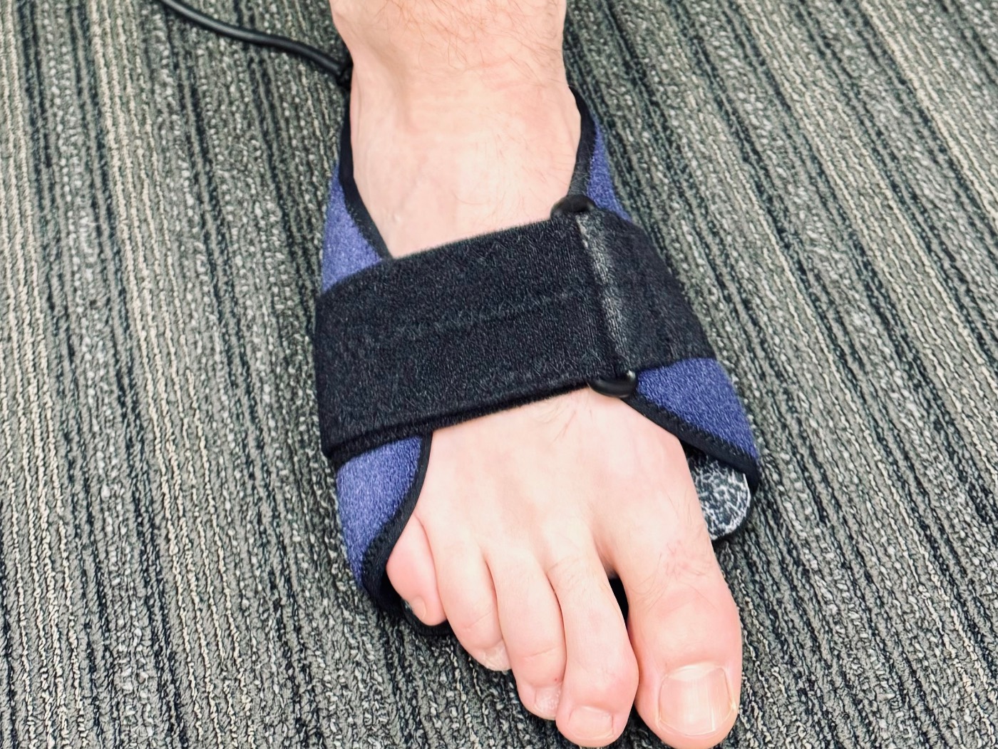 An infrared therapy pad wrapped around a patient's foot