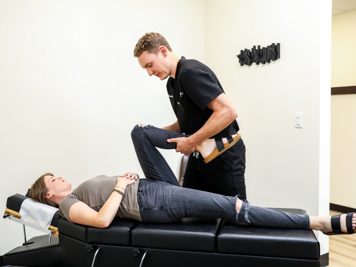 Dr. Emmerich working on a patient's leg on the table